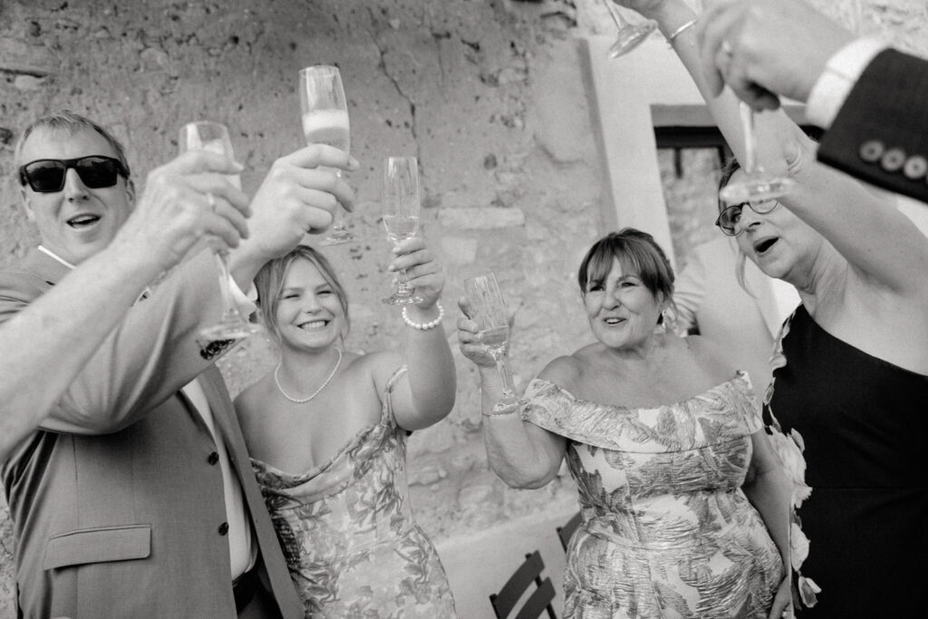 Candid wedding photography of guests cheering
